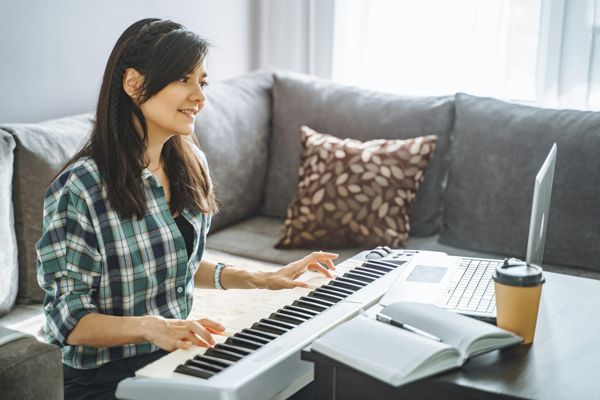Woman playing a MIDI Controller keyboard